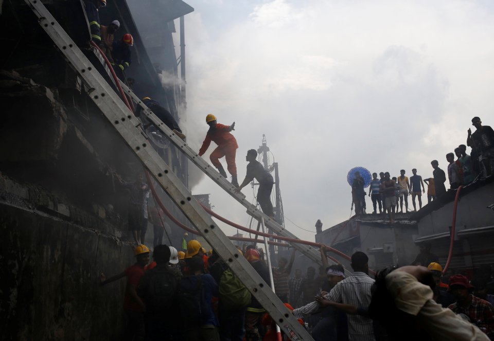  Firefighters extinguish a fire at a garment packaging factory outside of Dhaka, Bangladesh