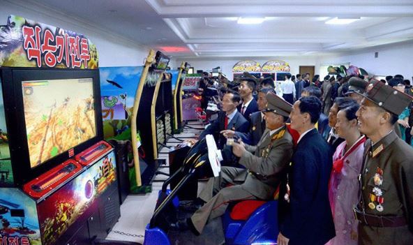 Delegates are seen enjoying playing a video game