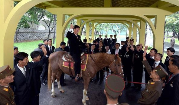 Bizarre moment a delegate rides a horse as crowds look on