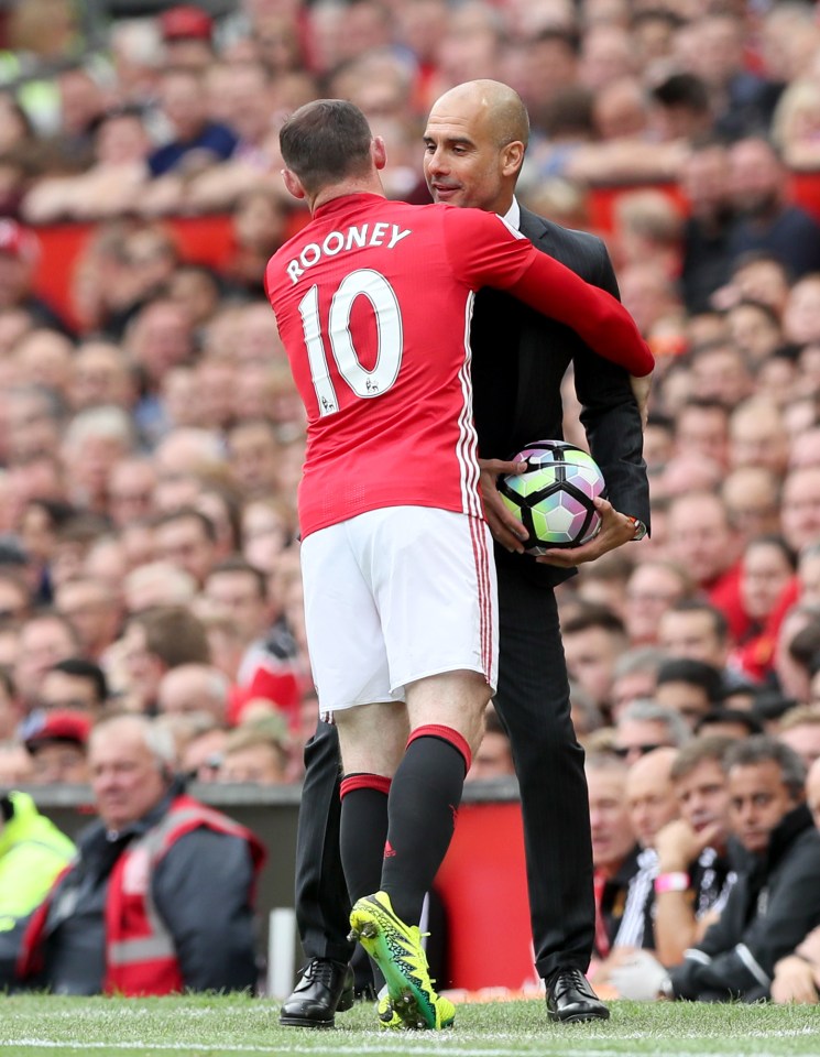  Guardiola puts the ball behind his back as Rooney tries to grab it