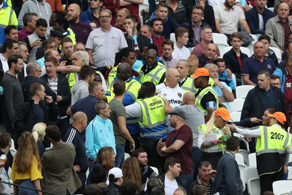  Stewards battle to control a section of fans during the West Ham game