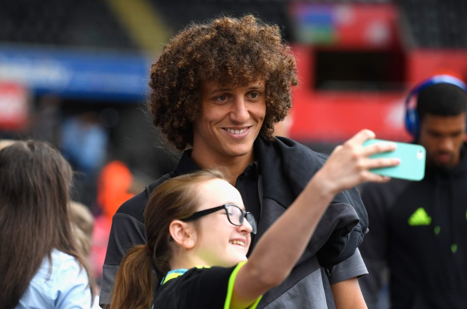  Luiz takes a selfie with a young fan ahead of Swansea game