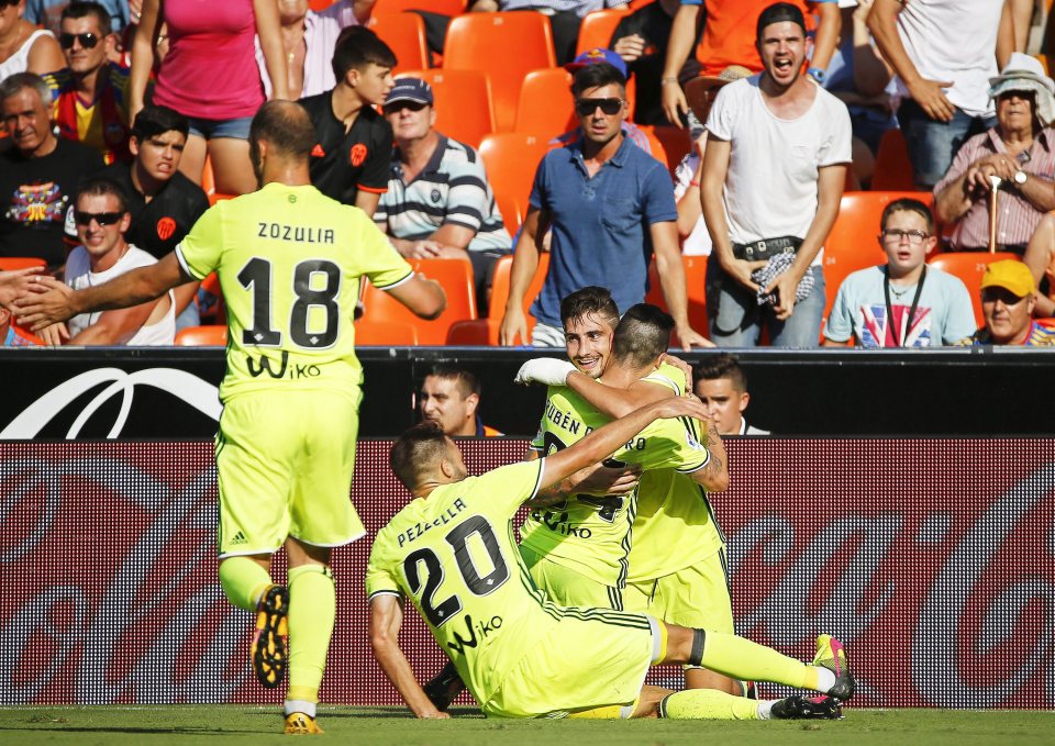  Ruben Castro is mobbed by Real Betis players after his 92nd minute goal secured a win at Valencia