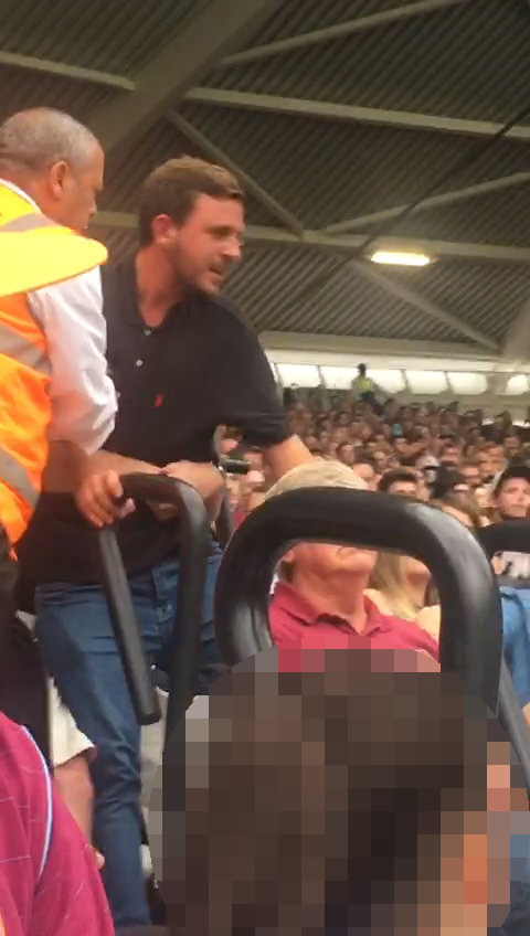  At one point a black-shirted thug comes close to the shocked children, having no regard for his surroundings