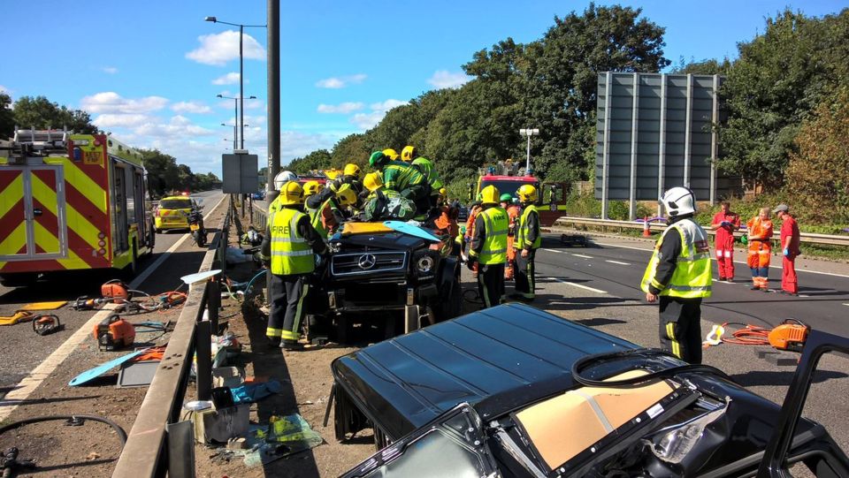  Firefighters are pictured attempting to free Souare from the vehicle