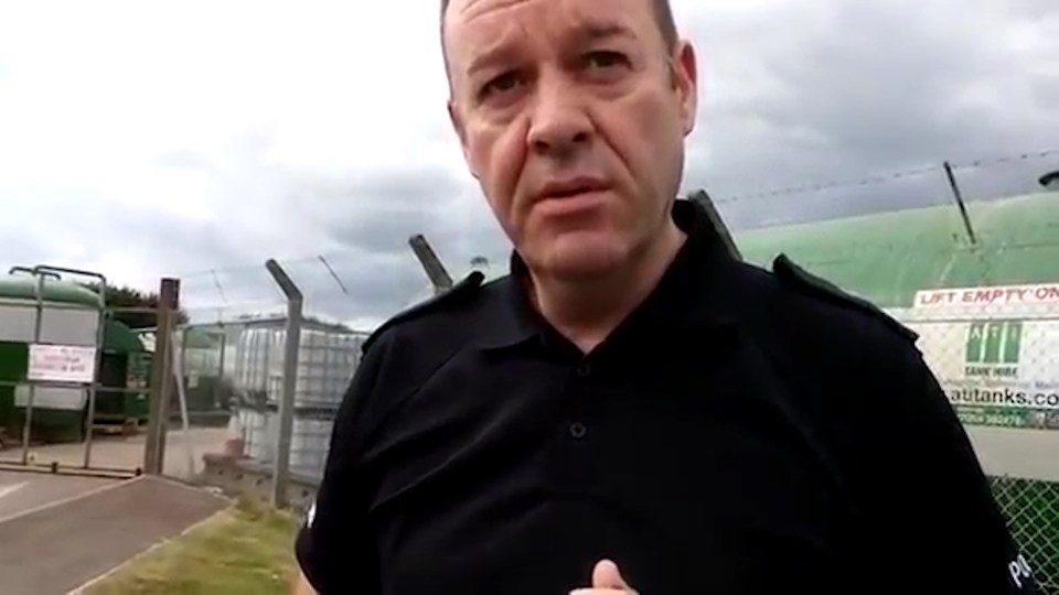  A police officer asks the unidentified man why he is filming the police station