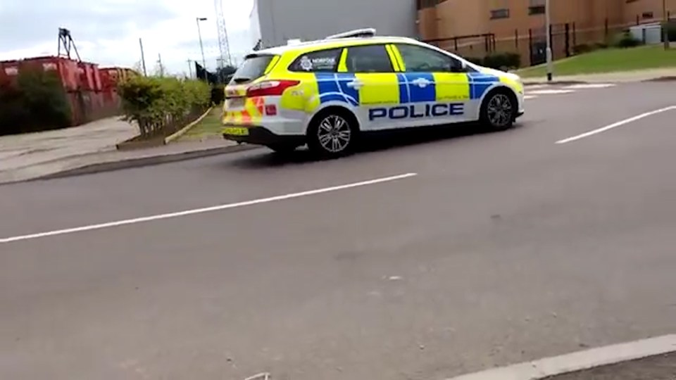  A police car is filmed by the man moments before he is spoken to by cops