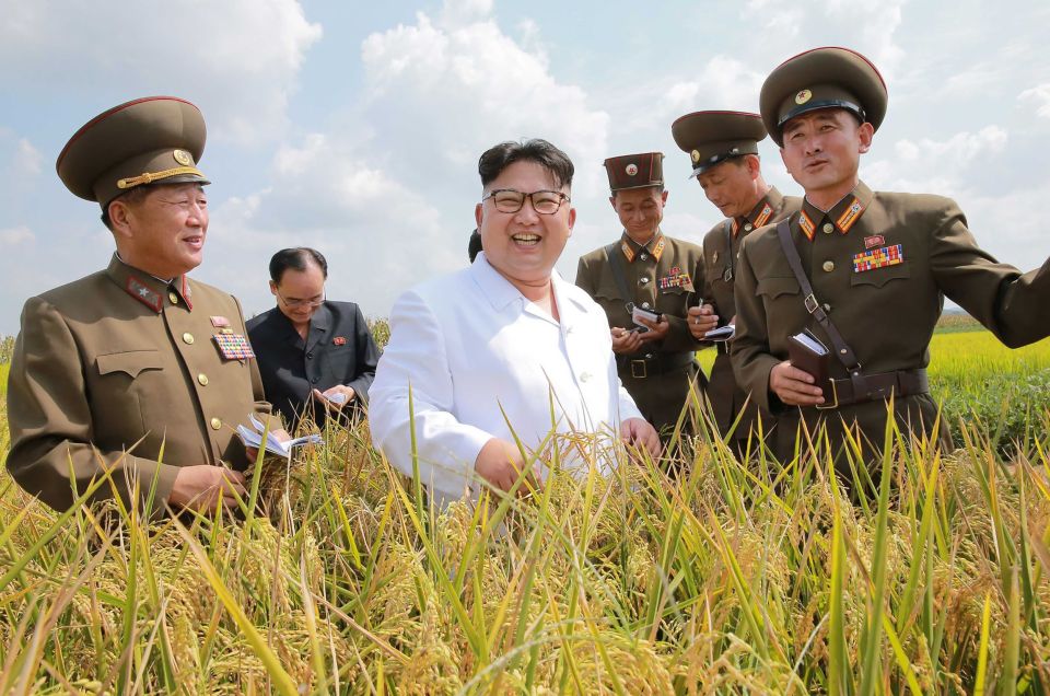  Kim with his military leaders on land near missile site