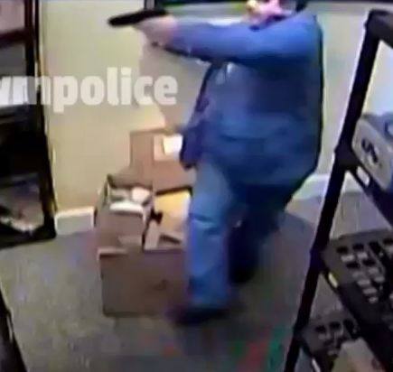  Dincer is seen retreating while holding an imitation firearm