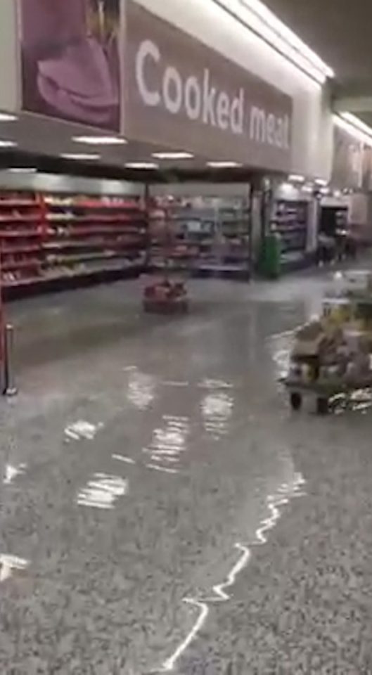 Water cascaded through an Asda supermarket in Greater Manchester following heavy rain yesterday