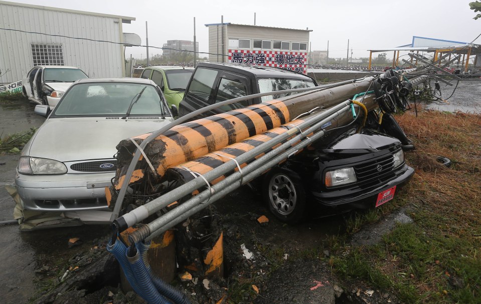  Vehicles are crushed by broken power lines as Super Typhoon Meranti batters Taiwan with 185mph winds