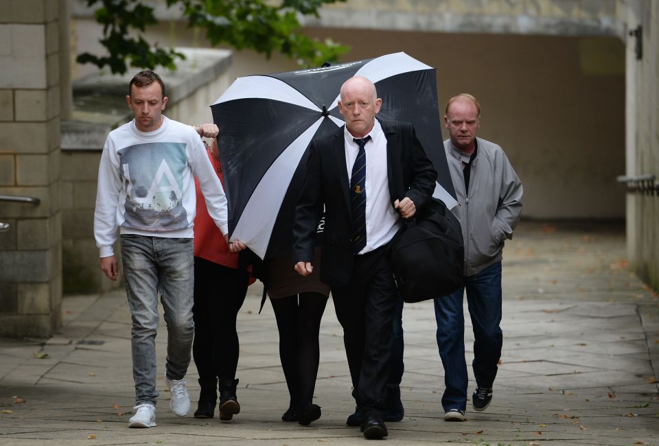  Claire Riley, 23, arrives at court hidden behind an umbrella