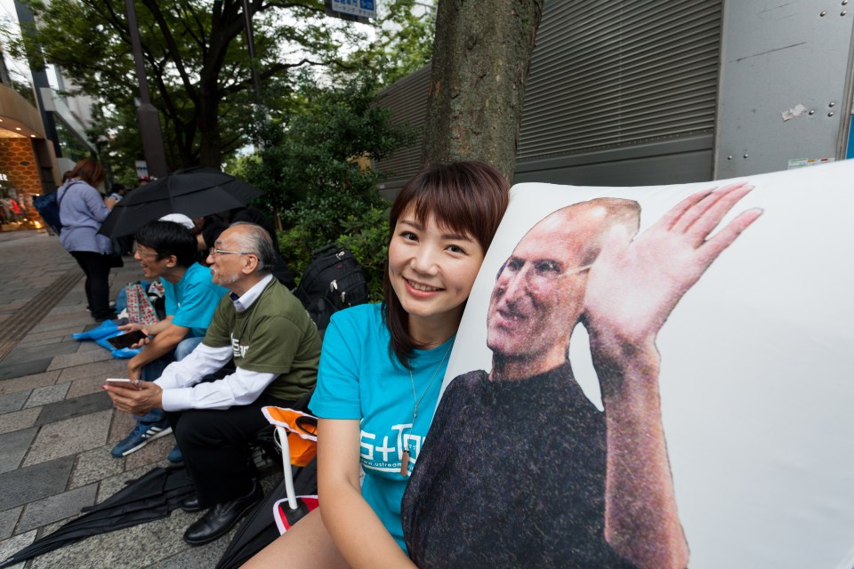  Ayano Tominaga poses with a Steve Jobs pillow before the Tokyo launch