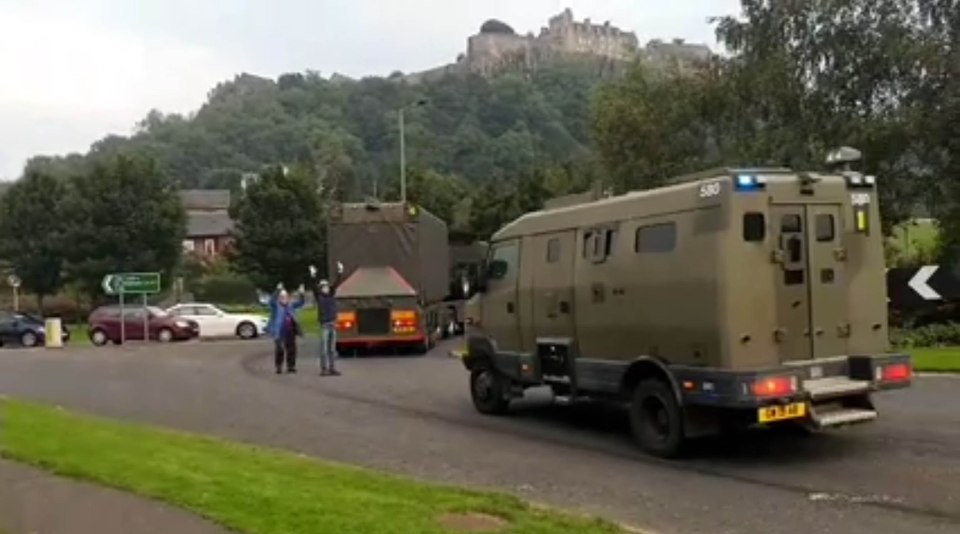  The two men - including a 77-year-old pensioner - appear in front of the convoy to hold up the traffic