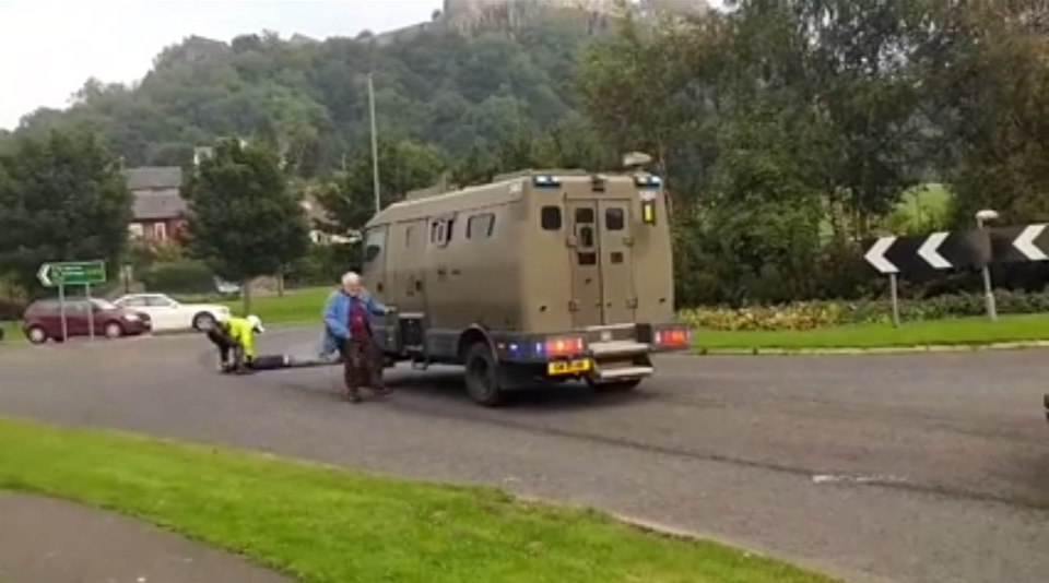  The older man runs, making his way to the wheel of the van in an attempt to stop the nuclear weapon convoy