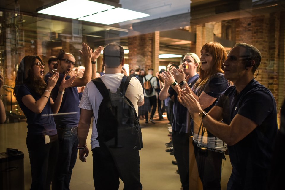  LONDON ... Staff cheered customers as they made their way to the central London Apple store in Covent Garden