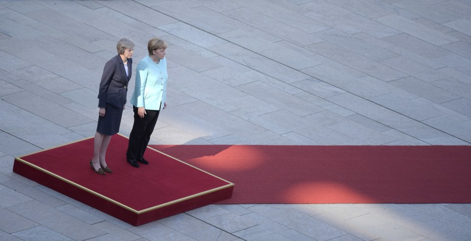  The lines of the paving stones against the diagonal line of the red carpet makes it look like Angela Merkel and Theresa May are leaning