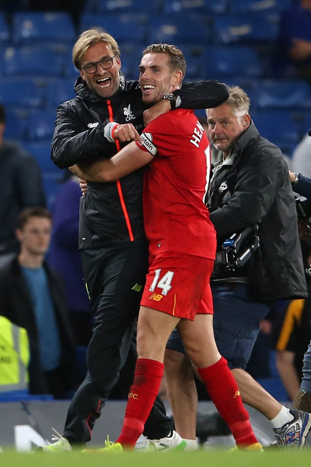  Jurgen Klopp celebrates with goal hero Henderson after the win