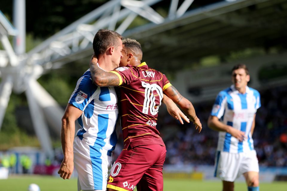  Town's Jonathan Hogg tussles with Tjarron Chery during the Championship clash