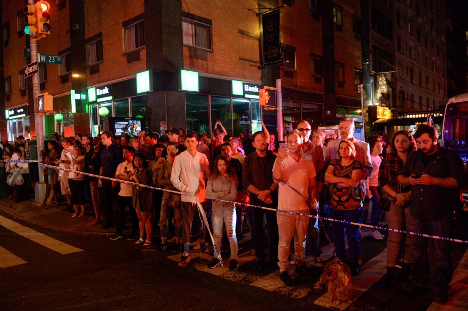  Onlookers stand behind a police cordon near the site of the explosion