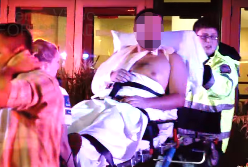  A man is taken away by medics after a knifeman went on the rampage in Minnesota