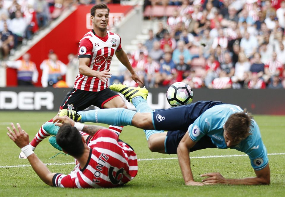  Swansea's Fernando Llorente is sent sprawling