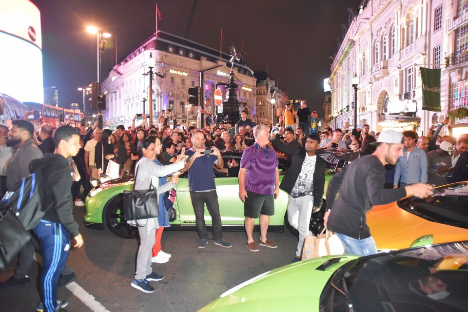  Petrolheads take the opportunity to get a souvenir snap as supercars descend on Piccadilly Circus in central London