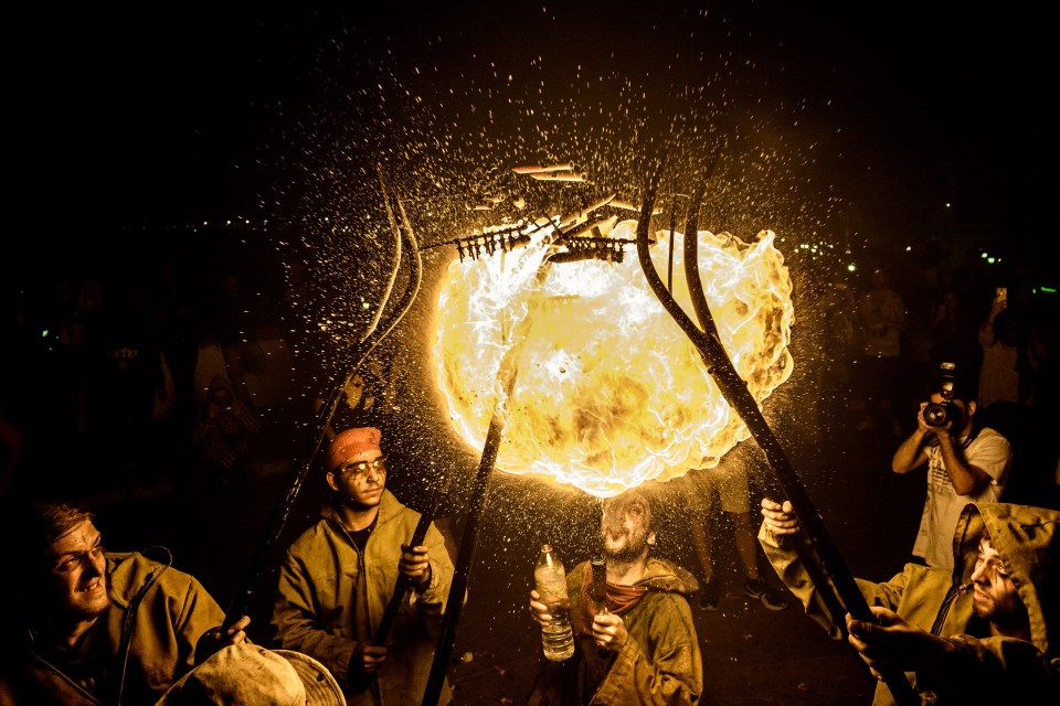  A fire breather creates a glowing orb of flame