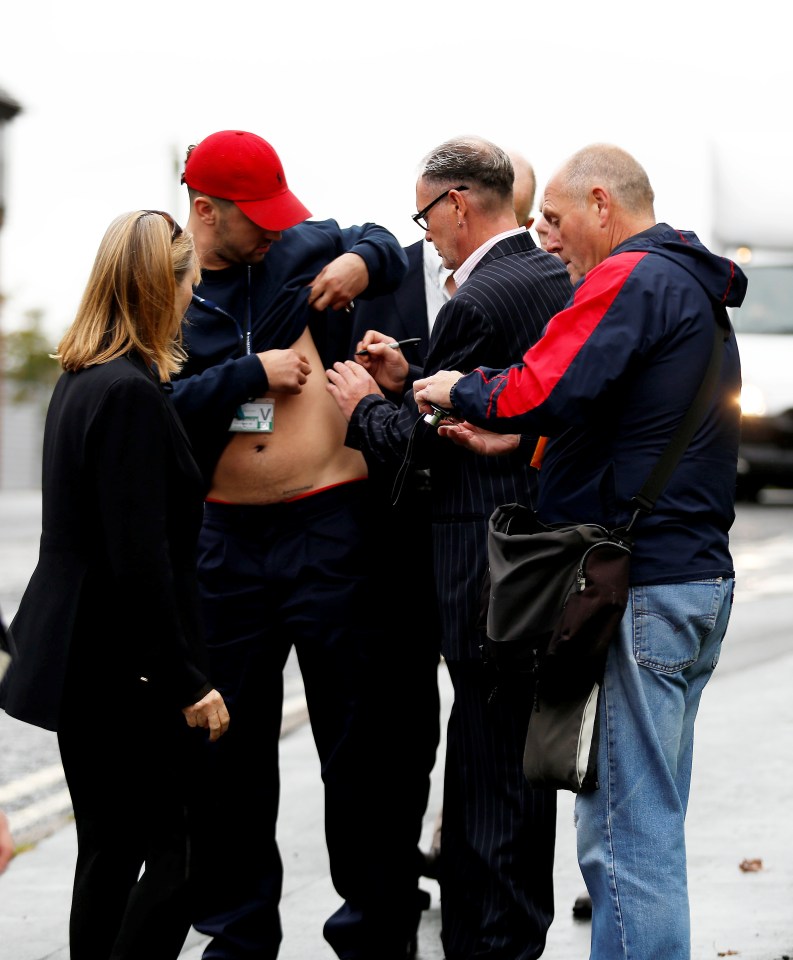  Gazza arrived at court and posed for selfies with awaiting fans even signing an autograph on one mans chest.