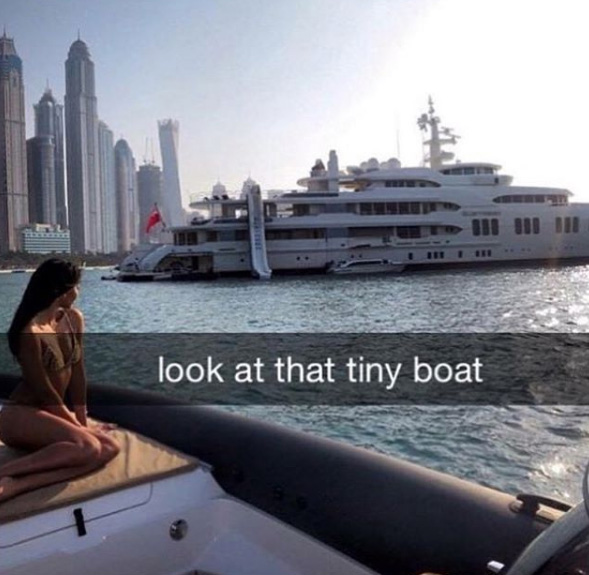  A girl ridicules a massive yacht