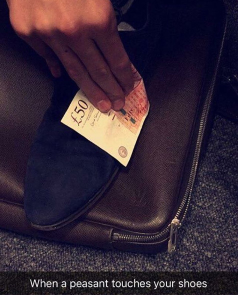  A guy wipes the dirt off his shoe with a £50 note