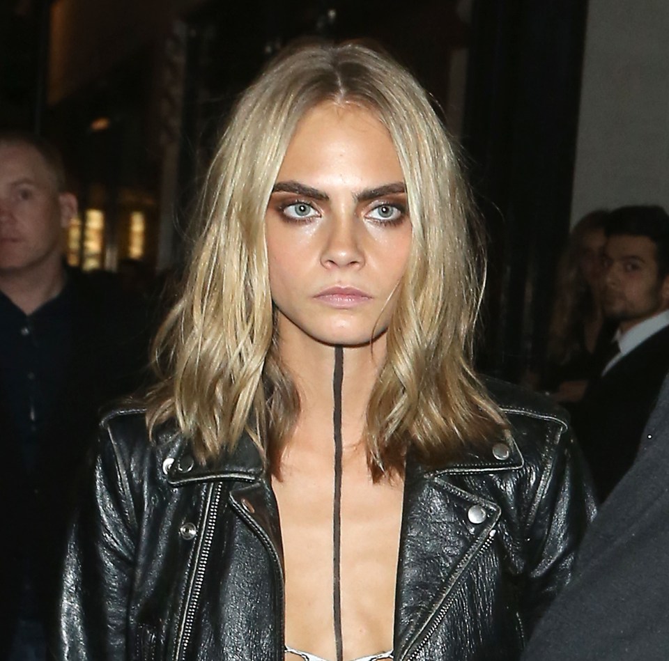  Cara Delevingne didn't look very happy as she left a London Fashion Week party