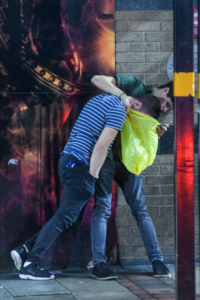  This young man was forced to hold up a plastic bag, while his friend vomited