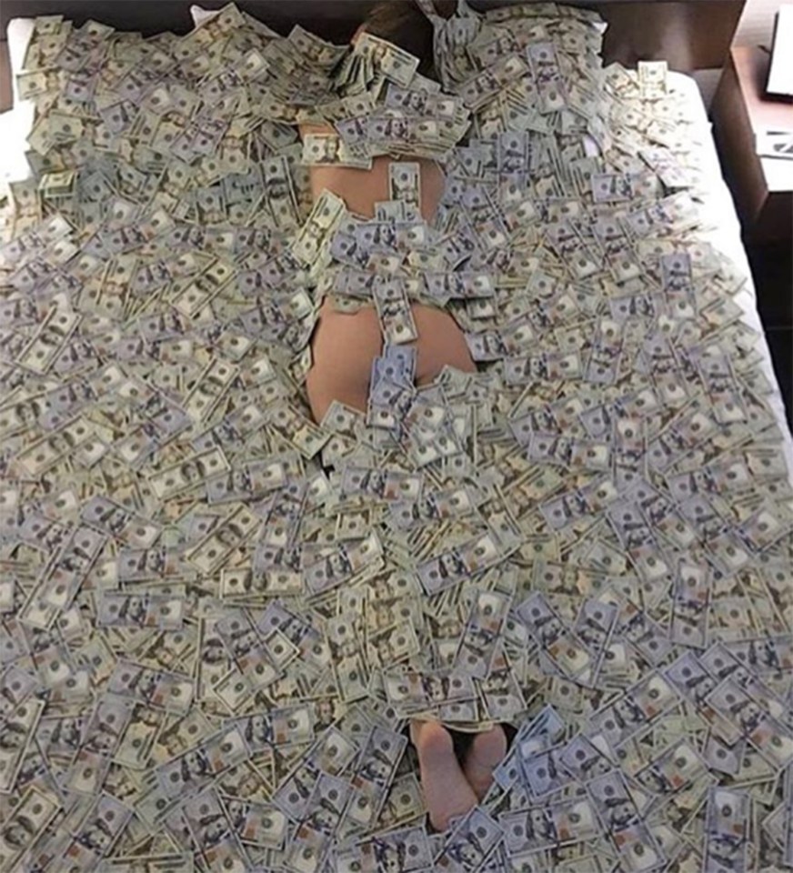  A Rich Kid lies down amongst hundreds of dollar bills