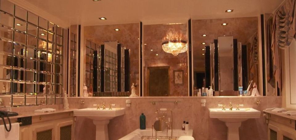  One of the impeccable bathrooms is lined with marble and mirrors