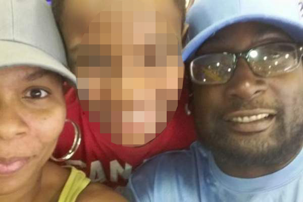 Scott's family say the 'great man and great father' was holding a book when he was shot