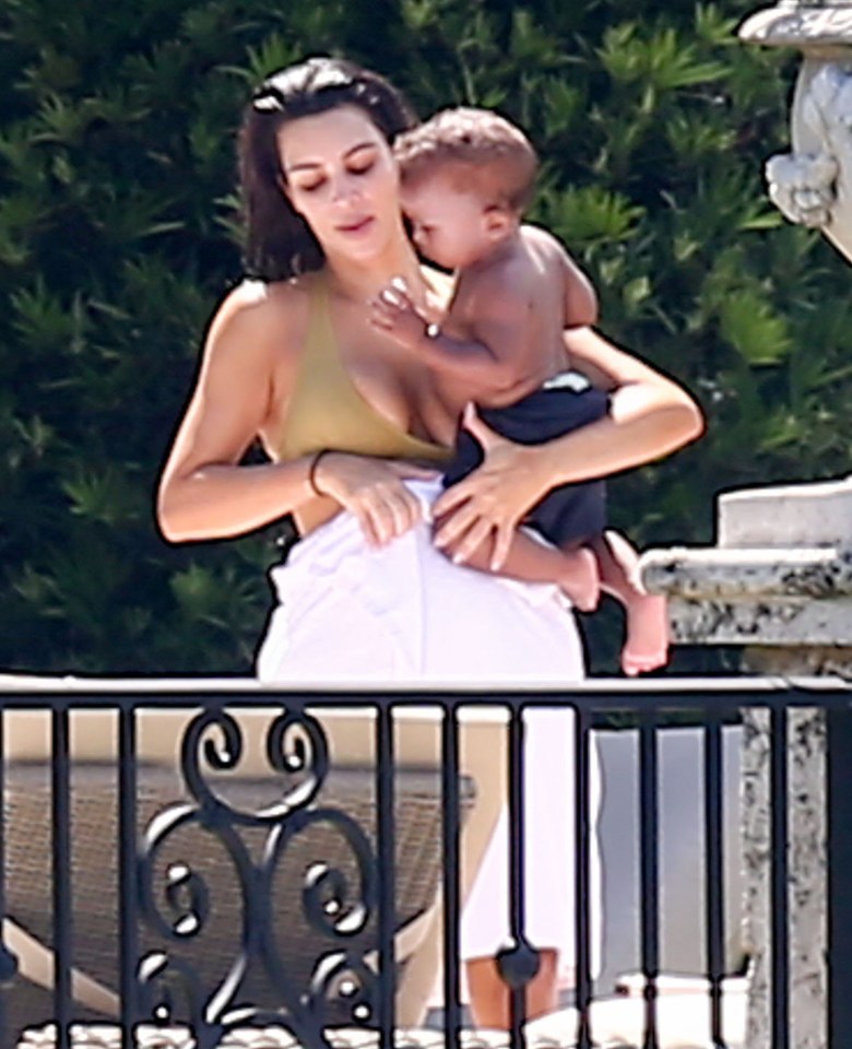  Kim gives her son Saint a cuddle