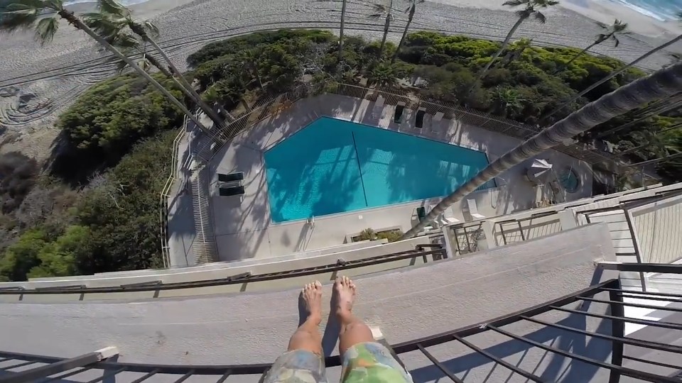  Once standing over the pool he waits a second before hurling himself off the balcony