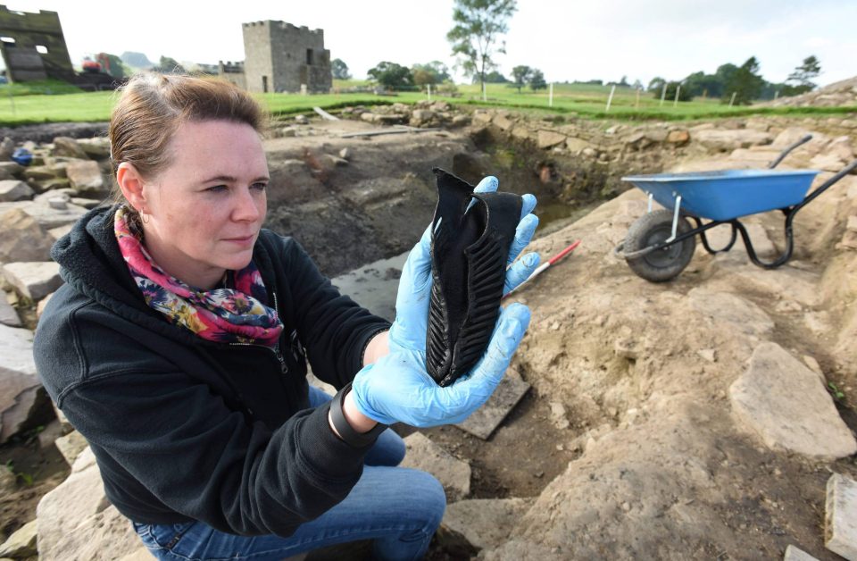  Vindolanda Trust curator Barbara Birley holding the leather shoe by the dig site at Vindolanda Roman Fort near Hadrian's Wall