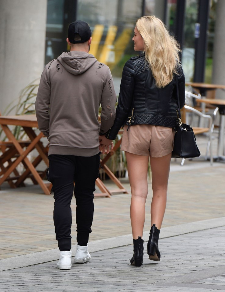  Danny Ings' companion gazes into the Liverpool striker's eyes during their stroll