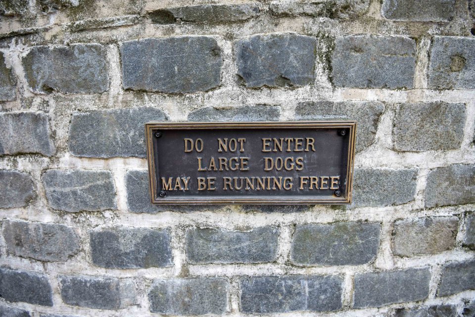  A brass sign on the gate warns 'Do not enter, large dogs may be running free'