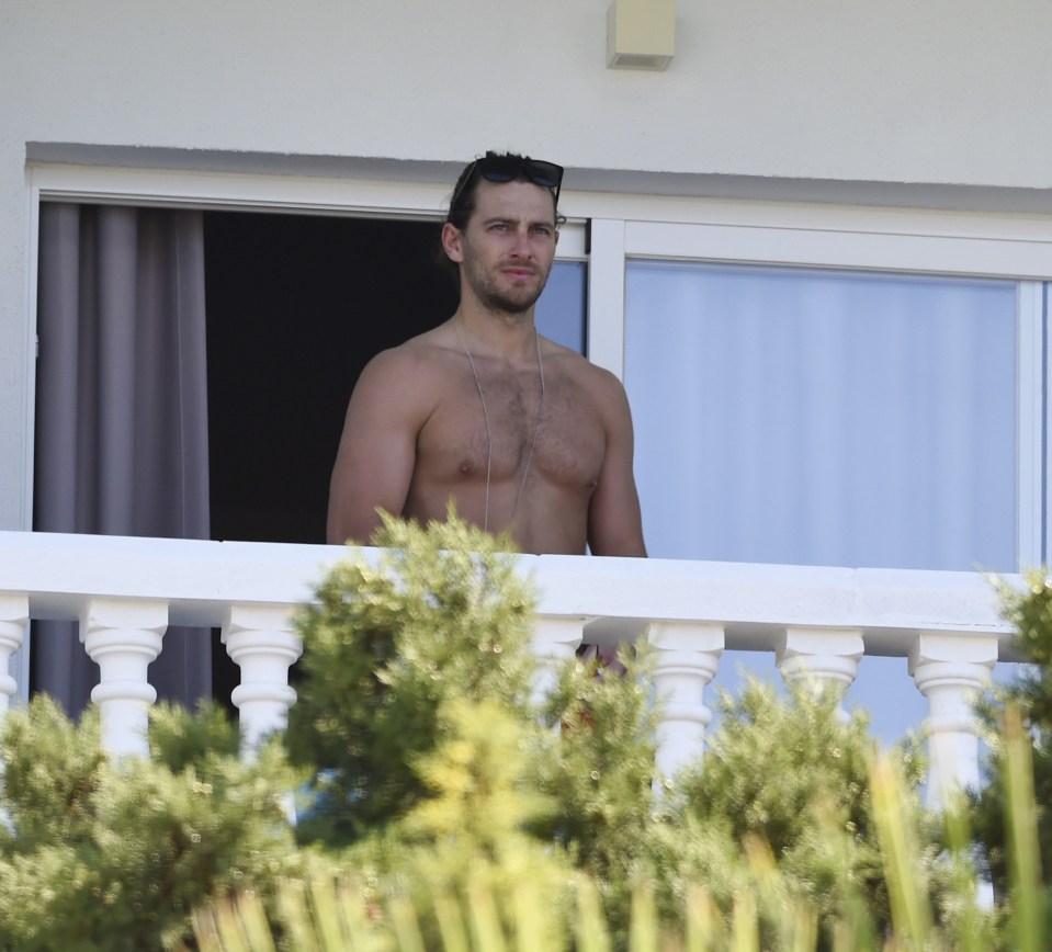 Ash showed off his toned physique on the balcony