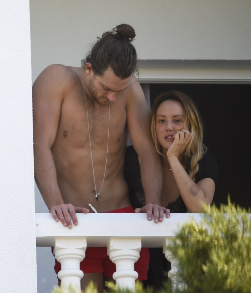 The pair cuddled up together on their balcony