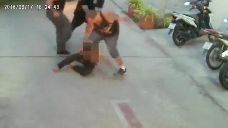  The men pin their victim to the ground as they rain blows down on him