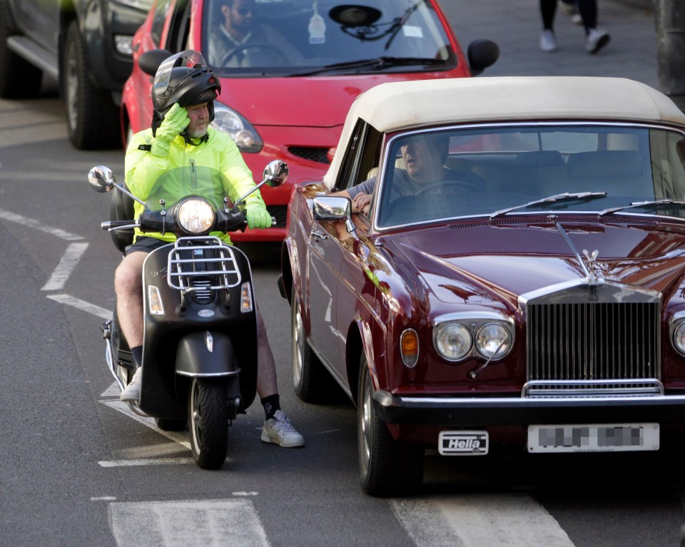  He lifted his helmet to chat to his mate