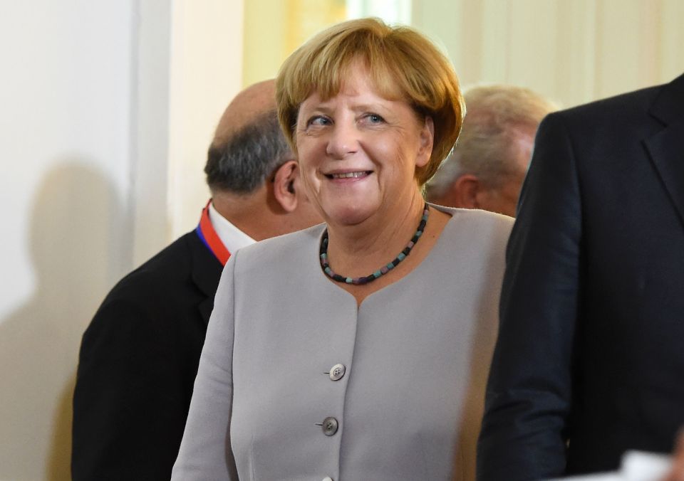  Deluded . . . Angela Merkel at migrant conference