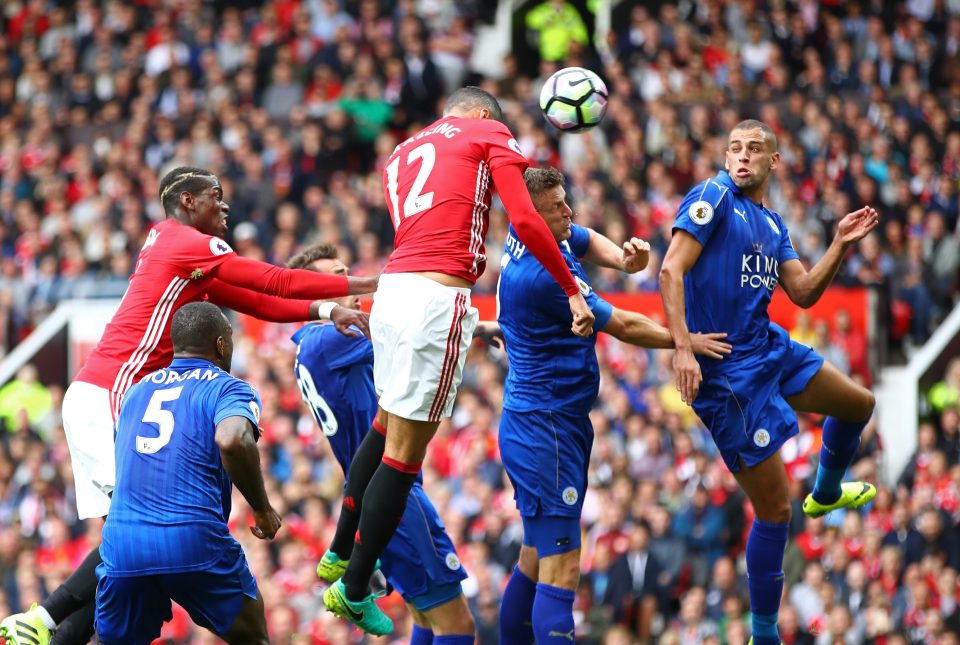  Chris Smalling rises above the Leicester defenders to head home United's opener