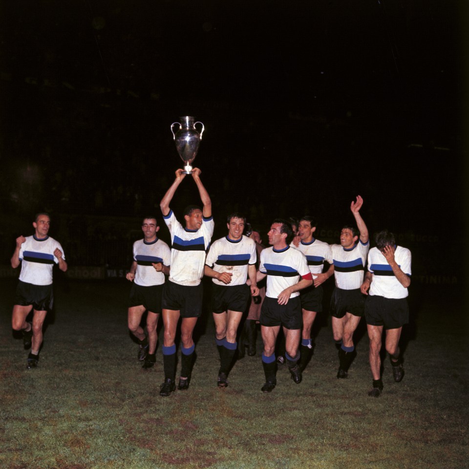 The players of Inter team are making a tour around the soccer field to celebrate the victory for the UEFA Champions League Cup. From left, Luis Suarez, Mario Corso, Jair Da Costa (with the cup), Gianfranco Bedin, Armando Picchi (captain), Aristide Guarneri, Tarcisio Burgnich, Luca Joaquin Peir= (who is hiding his face for the happiness he is feeling). Milan, May 27, 1965. (Photo by Mario De Biasi;Sergio Del Grande;Giorgio Lotti;Walter Mori/Mondadori Portfolio via Getty Images)