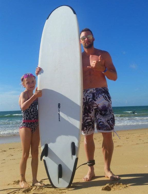  She was injured minutes after this photo was taken during her first ever surfing lesson with dad