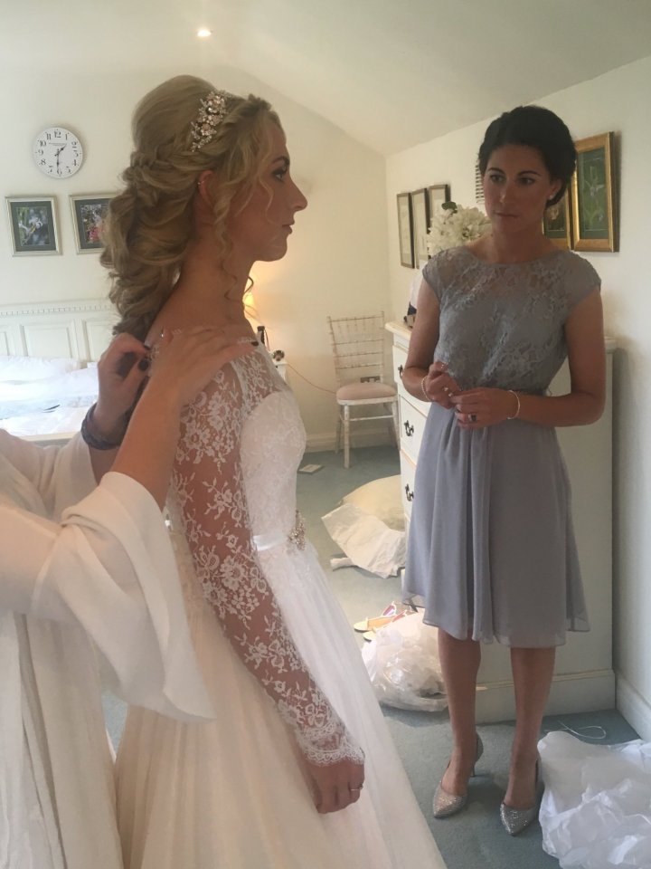  Laura tries out the dress with her sister before the ceremony